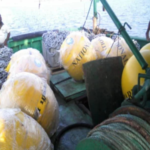 Buoys and chain baskets stacked on deck for the run out to the islands